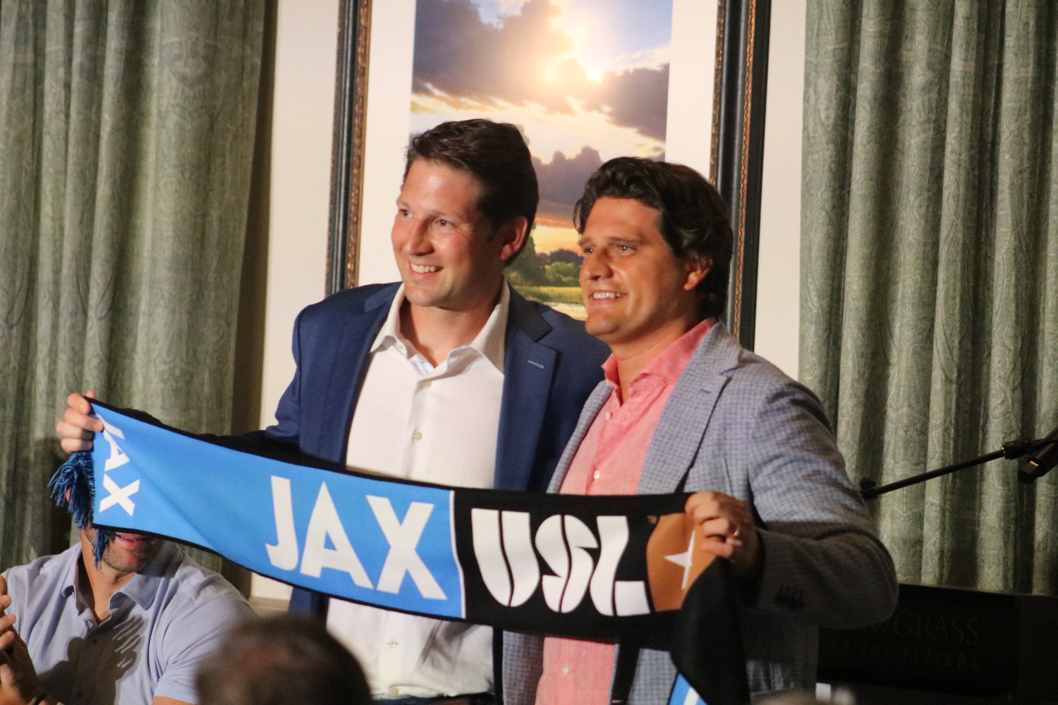 Founding owner Ricky Caplin and USL CEO Alec Papadakis hold up a JAXUSL scarf.